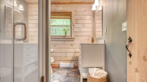 a bathroom with a shower and a sink at Half Moon by AvantStay 4BR Cabin w Large Deck Yard w Patio Outdoor Dining in Great Barrington