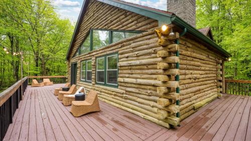 a log cabin with chairs on a wooden deck at Half Moon by AvantStay 4BR Cabin w Large Deck Yard w Patio Outdoor Dining in Great Barrington