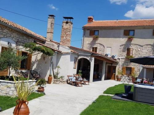 a courtyard of a house with a patio at Double room with terrace in Loborika