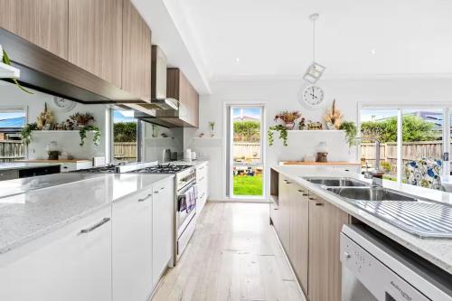 a kitchen with wooden cabinets and white appliances at Gardenia Serenity & Wellness Retreat in Officer