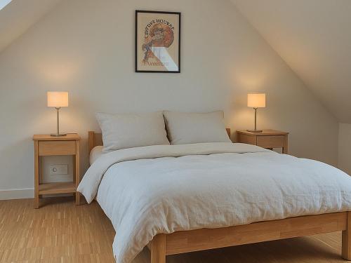 a bedroom with a large bed with two night stands at Superbe maison neuve à Groix, proche bourg - FR-1-813-2 in Groix