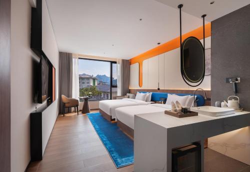 a hotel room with a large bed and a bathroom at Zhangjiajie Yujie Hotel in Zhangjiajie