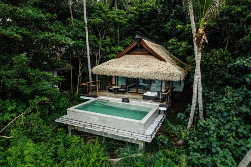 an aerial view of a house with a swimming pool at El Nido Resorts Pangulasian Island in El Nido