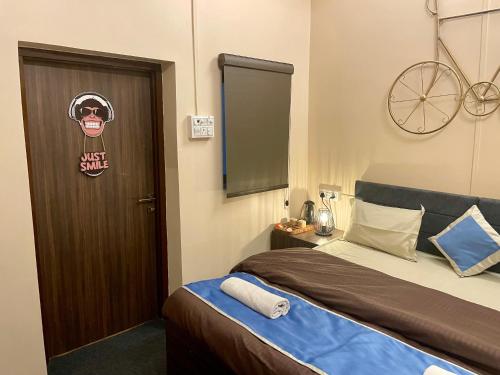 a bedroom with a bed and a door with a bike sign at Hotel Kashi Awahan! Near Vishvanath Temple in Varanasi