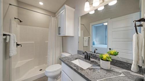 Un baño con lavabo, inodoro y ducha. en Resort Pool Walk to the Beach Island Views Little Beach House by AvantStay, en Port Aransas