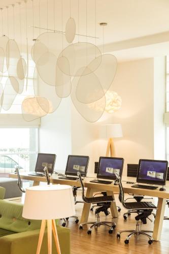an office with four desks with laptops on them at Fiesta Inn Periferico Sur in Mexico City