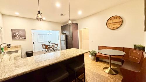 a kitchen and living room with a clock on the wall at Modern 2 BR, Unwind in a Prime Location, with Parking in San Jose