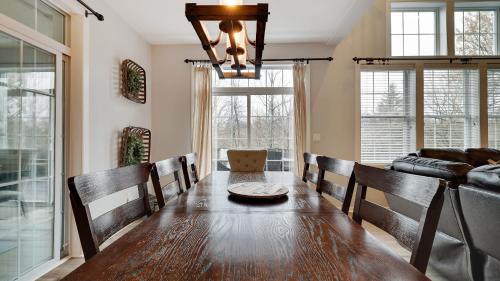 a dining room with a table and a couch at The Nest at Pinecrest by AvantStay Spacious Deck Game Room Fire Pit in Pocono Pines
