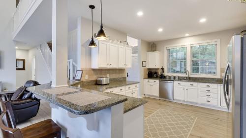 a kitchen with white cabinets and a counter top at The Nest at Pinecrest by AvantStay Spacious Deck Game Room Fire Pit in Pocono Pines