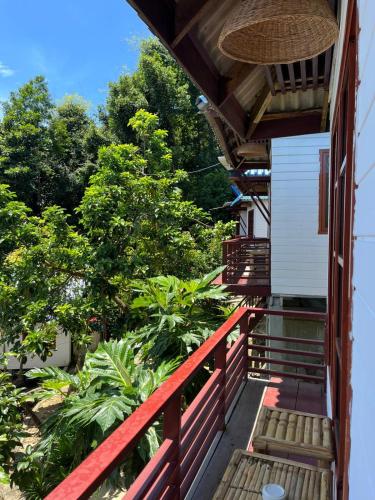 a balcony of a house with a red railing at The Hideout Koh Rong in Koh Rong