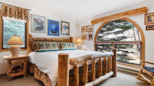 a bedroom with a bed and a large window at Riverside Condos B101 by AvantStay Condo Close To Downtown Town Park Ski Lift 8 in Telluride