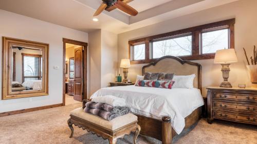 a bedroom with a bed and a chair and a mirror at Heritage by AvantStay Luxe Oregon Retreat Deck in Powell Butte