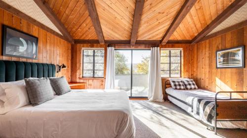 a bedroom with a large bed and a window at Cathedral by AvantStay Charming Secluded Estate w Sauna Pool Table Views of the Rolling Hills in Paso Robles