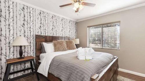 a bedroom with a bed and a ceiling fan at Dawn and Dusk by AvantStay Modern Cabin in Great Location w Home Theatre in Big Bear Lake