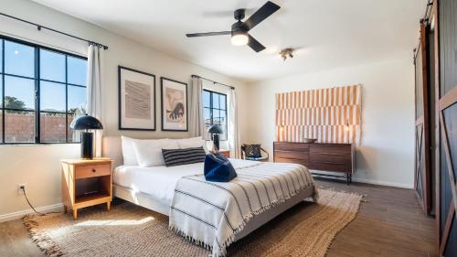 a bedroom with a bed and a ceiling fan at Flora by AvantStay Modern Private Desert Oasis on Large Grounds w Pool Bocce Ball in Yucca Valley