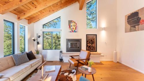 a living room with a couch and a fireplace at Trapper by AvantStay A Interior Design w Sauna in Alpine Meadows