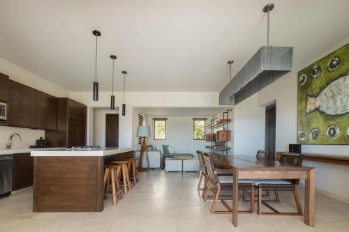 a kitchen and dining room with a table and chairs at Live Aqua Private Residences Los Cabos in Cabo San Lucas