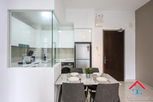 a kitchen with a table and chairs in a kitchen at Astoria Ampang By Grabstay in Kuala Lumpur