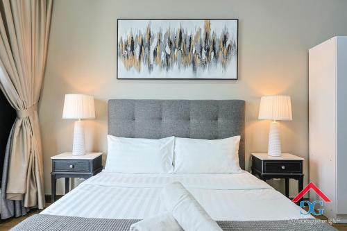 a bedroom with a large bed with two night stands at Astoria Ampang By Grabstay in Kuala Lumpur
