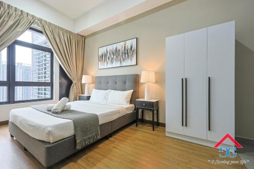 a bedroom with a bed and a large window at Astoria Ampang By Grabstay in Kuala Lumpur