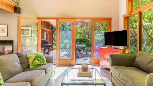a living room with a couch and a tv at Rhythm Waters by AvantStay Garden Paradise Pond in Langley