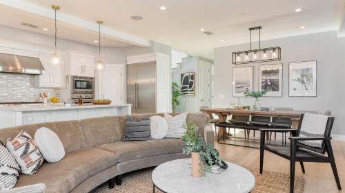 a living room and kitchen with a couch and a table at Sea Crown by AvantStay 5mins from the Beach w Multiple Terraces PermitSLP13639 in Newport Beach