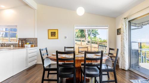 a kitchen and dining room with a table and chairs at Saratoga by the Sea by AvantStay Panoramic View Near Langley in Langley
