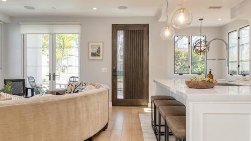 a kitchen and living room with a couch and a table at Sea Crown by AvantStay 5mins from the Beach w Multiple Terraces PermitSLP13639 in Newport Beach