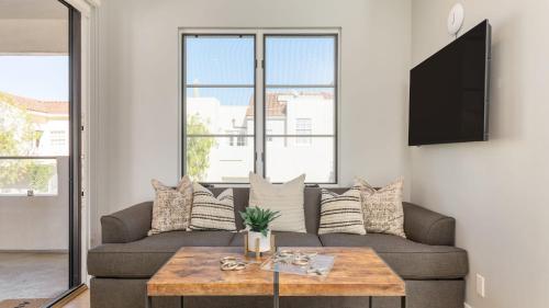 a living room with a couch and a table at Sea Crown by AvantStay 5mins from the Beach w Multiple Terraces PermitSLP13639 in Newport Beach