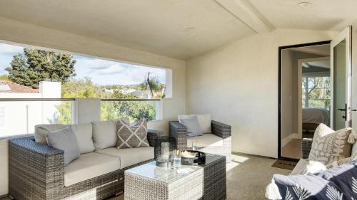 a living room with a couch and a table at Sea Crown by AvantStay 5mins from the Beach w Multiple Terraces PermitSLP13639 in Newport Beach