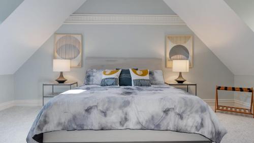 a bedroom with a large bed with two lamps at Hamersmith Hollow Retreat Estate by AvantStay Great Views in Mars Hill