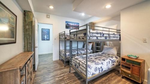 a bedroom with two bunk beds and a desk at Port A Hideaway by AvantStay Private Pool in Port Aransas