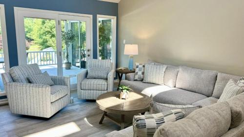 a living room with a couch and two chairs and a table at Sip Sip Away by AvantStay Pool Hot Tub in Westport
