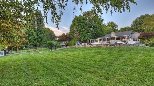 a large lawn in front of a house at Sip Sip Away by AvantStay Pool Hot Tub in Westport