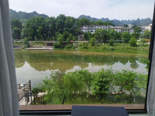 a view of a lake from a window at XI SHANG YUN JIAN Inn in Hanqiyu