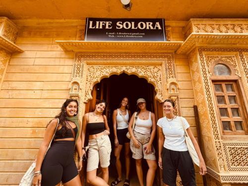 a group of women standing in front of a building at Life Solora Jaisalmer in Jaisalmer