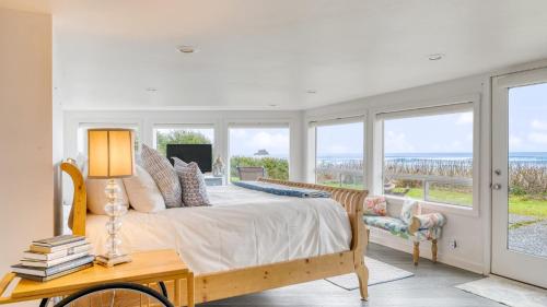 a bedroom with a bed with a view of the ocean at Sanctuary by the Sea by AvantStay Waterfront Views in Arch Cape