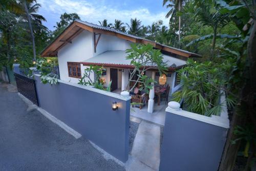 a house with a blue door and a fence at Onadi House in Galle