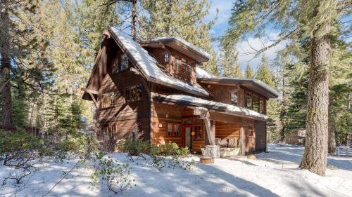a log cabin in the woods in the snow at Ward Creek by AvantStay 5 Min Walk to Lake Deck in Tahoe City