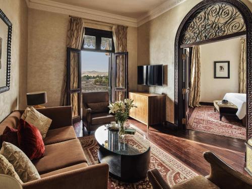 a living room with a couch and a table at Sofitel Legend Old Cataract in Aswan