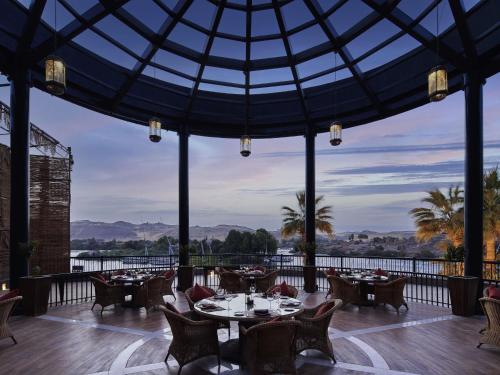 a restaurant with tables and chairs and a glass ceiling at Sofitel Legend Old Cataract in Aswan