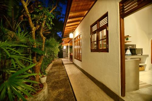 a hallway of a house with plants on the side at Onadi House in Galle
