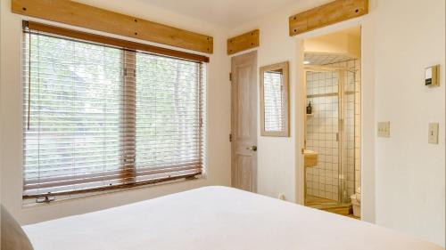 a bedroom with a bed and a large window at Double Diamond 23 by AvantStay Close to Town The Slopes in Telluride