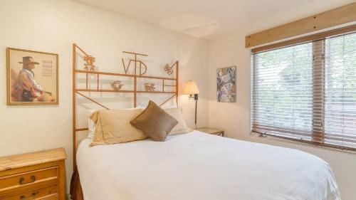 a bedroom with a white bed and a window at Double Diamond 23 by AvantStay Close to Town The Slopes in Telluride