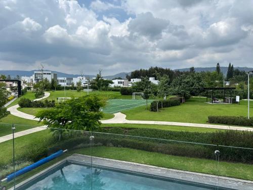 a view of a park with a swimming pool at Residencial Santa Anita in San Agustín