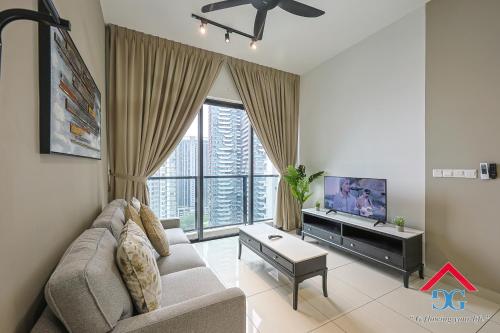 a living room with a couch and a tv at Astoria Ampang By Grabstay in Kuala Lumpur
