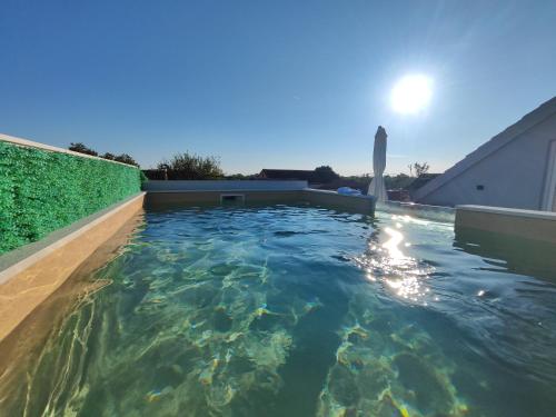 a swimming pool in the backyard of a house at Apartments with swimming pool Bacici, Krka - 24721 in Drinovci