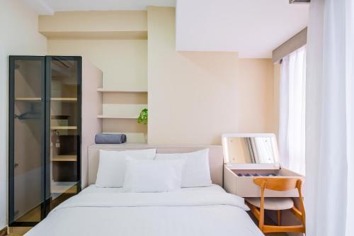 a bedroom with a bed and a desk with a computer at Tokyo Riverside Apartment @ PIK 2 in Tangerang