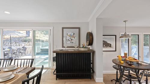 a kitchen and dining room with a table and chairs at Hidden Oaks Farmhouse by AvantStay Hot Tub Deck in Atascadero