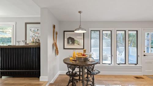 a kitchen with a table with a bowl of fruit on it at Hidden Oaks Farmhouse by AvantStay Hot Tub Deck in Atascadero